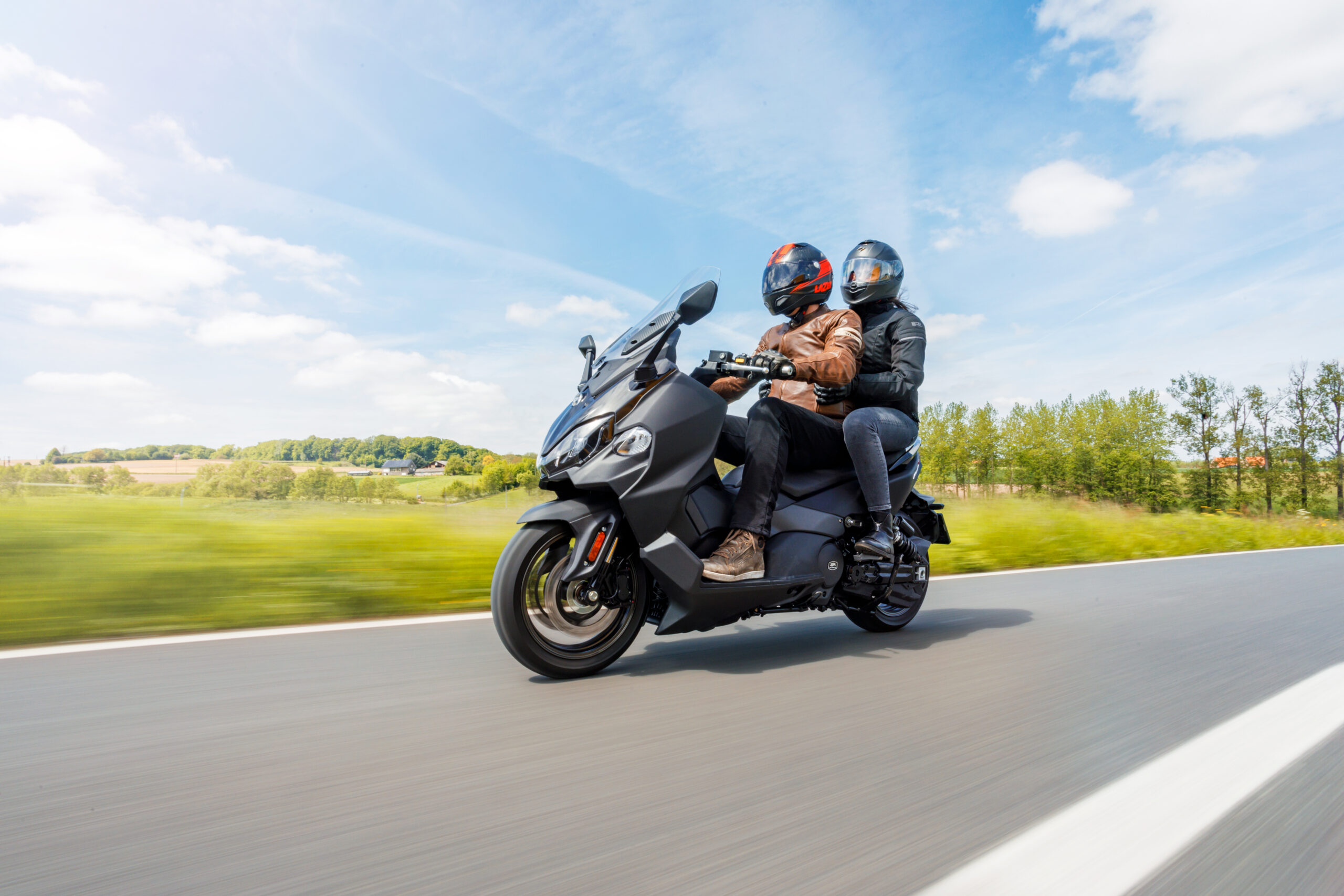 image des scooter avec deux personne sur la route